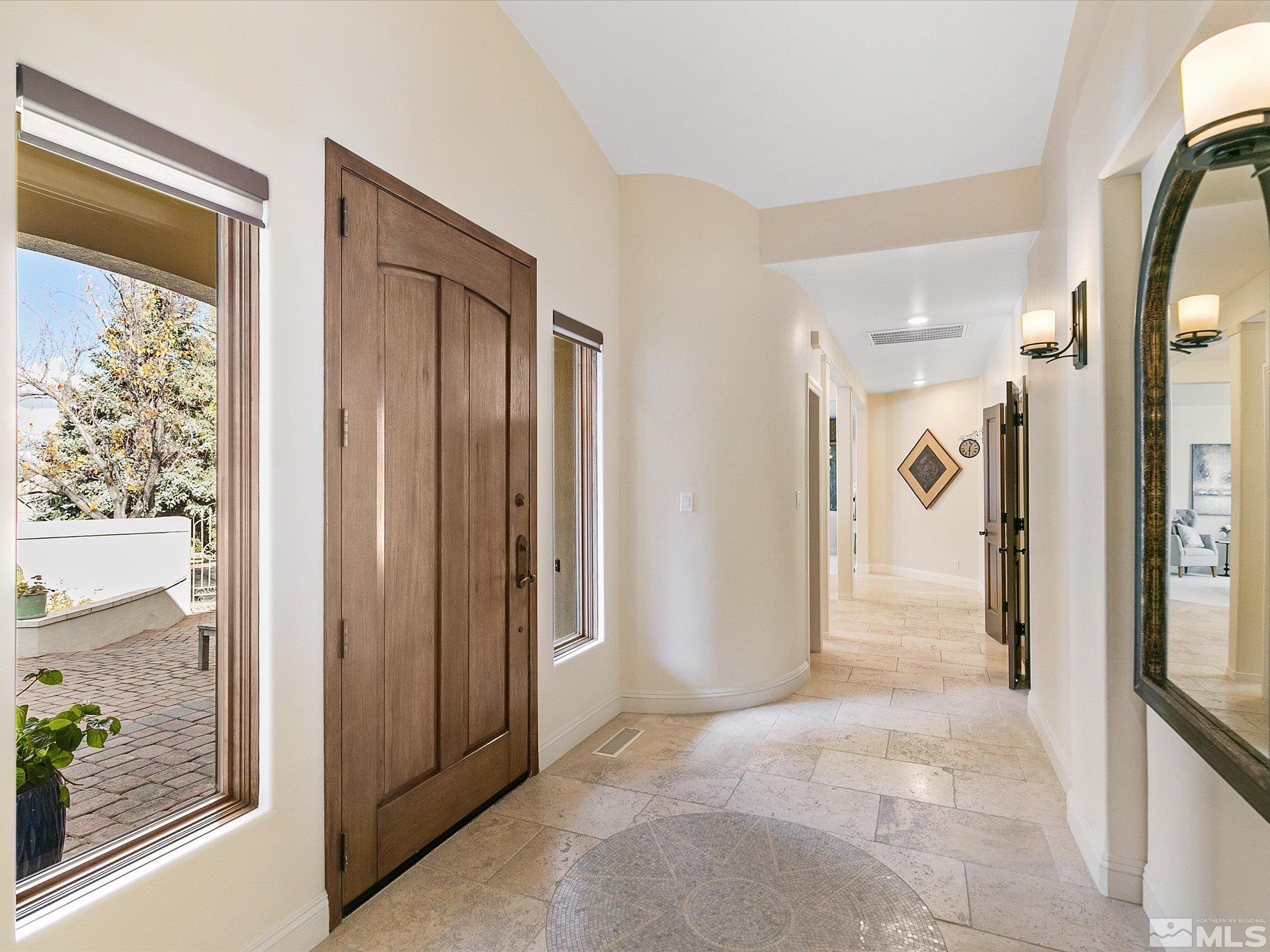 100 Sawbuck Road Reno, NV 89519 - Photo 7 of 40 a view of a hallway with wooden floor and a bathroom