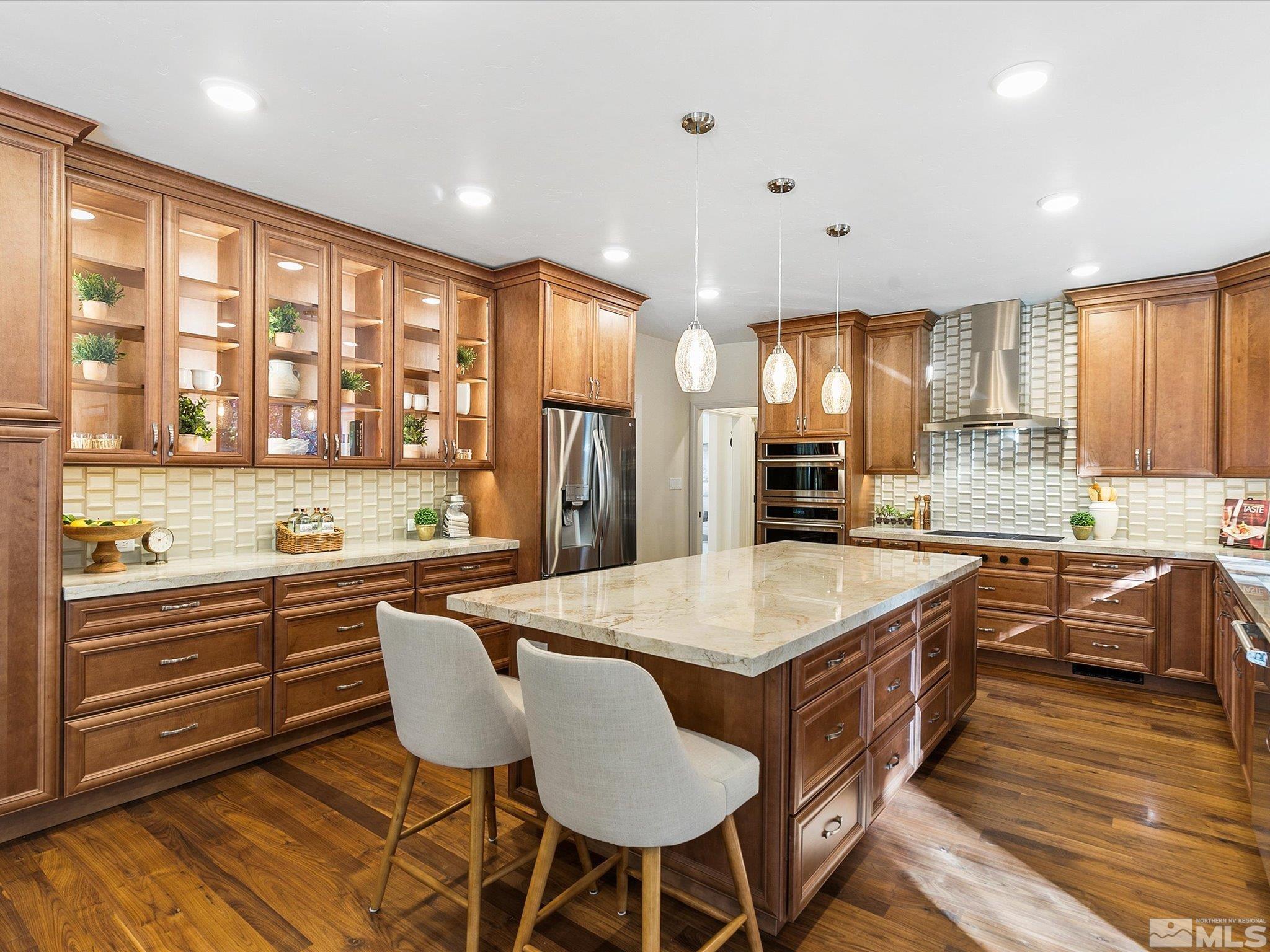 100 Sawbuck Road Reno, NV 89519 - Photo 9 of 40 a large kitchen with kitchen island a large island in it