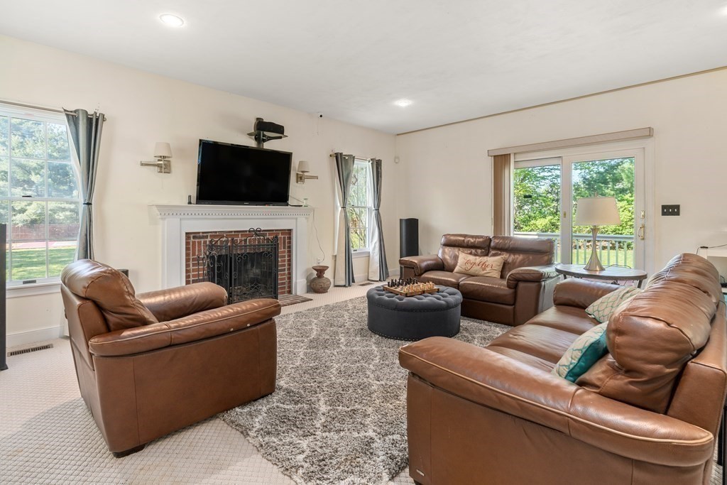 15 Dakin Road Sudbury, MA 01776 - Photo 2 of 42 a living room with furniture a fireplace and a flat screen tv