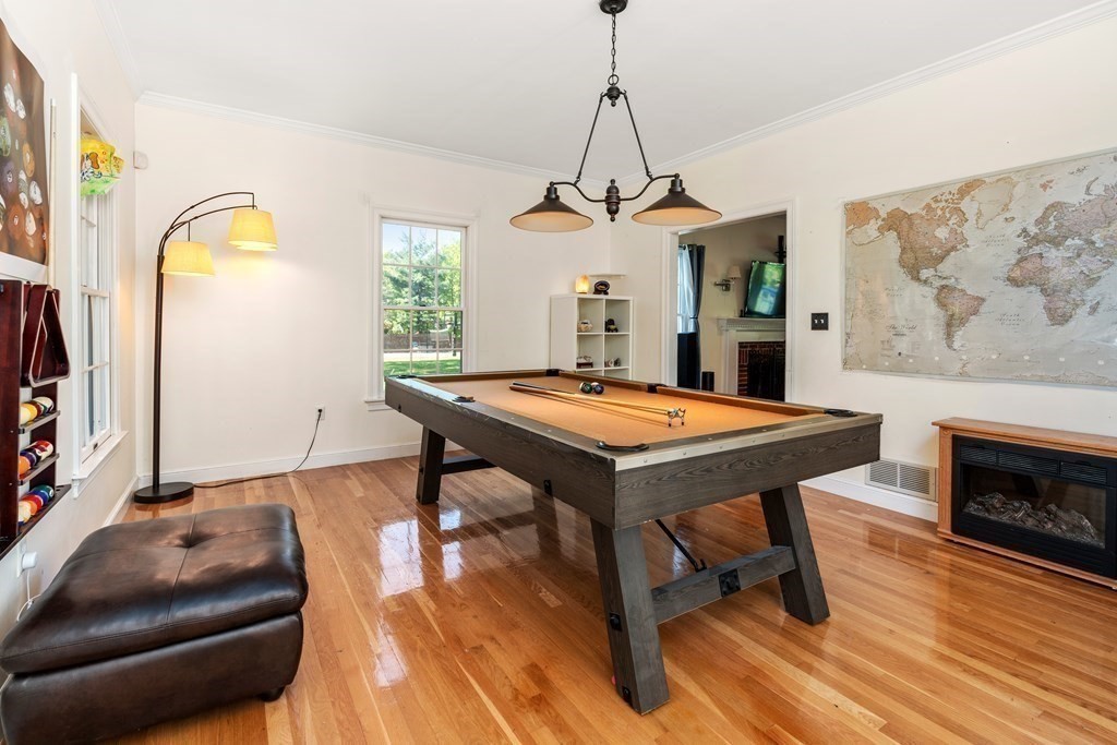 15 Dakin Road Sudbury, MA 01776 - Photo 8 of 42 a living room with a table chairs and a chandelier