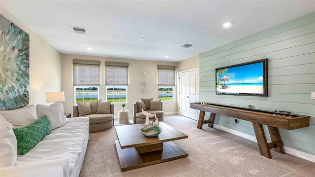 a living room with furniture a rug and a large window