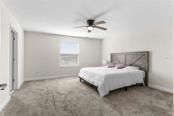 a bedroom with a bed and window