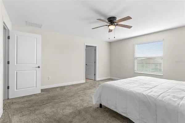 a bedroom with a bed and window