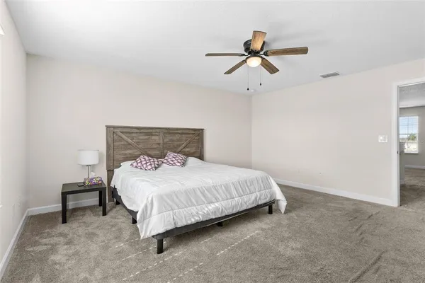 a bedroom with a bed and window