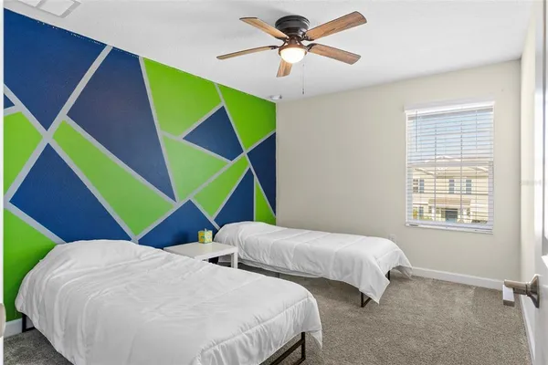 a bedroom with 2 bed and a painting