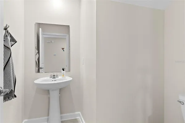 a bathroom with a sink a mirror and toilet