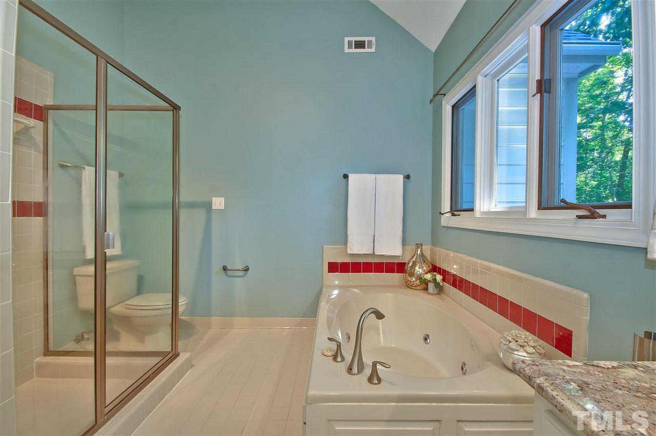 6108 Fetlock Drive Raleigh, NC 27613 - Photo 15 of 25 a bathroom with a bathtub and a shower