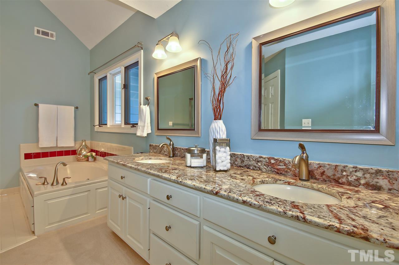 6108 Fetlock Drive Raleigh, NC 27613 - Photo 16 of 25 a bathroom with a sink double vanity granite and a mirror