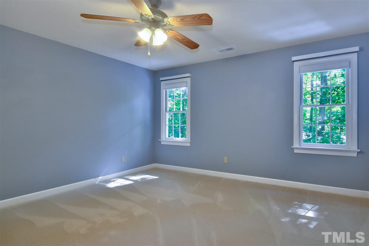 6108 Fetlock Drive Raleigh, NC 27613 - Photo 17 of 25 a view of a big room with windows and chandelier fan