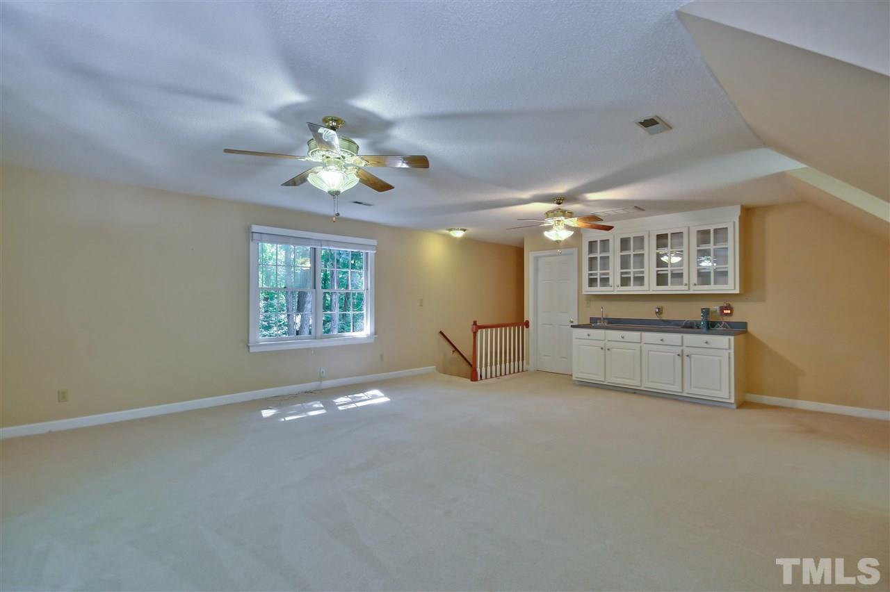 6108 Fetlock Drive Raleigh, NC 27613 - Photo 20 of 25 a view of an empty room with window and a kitchen