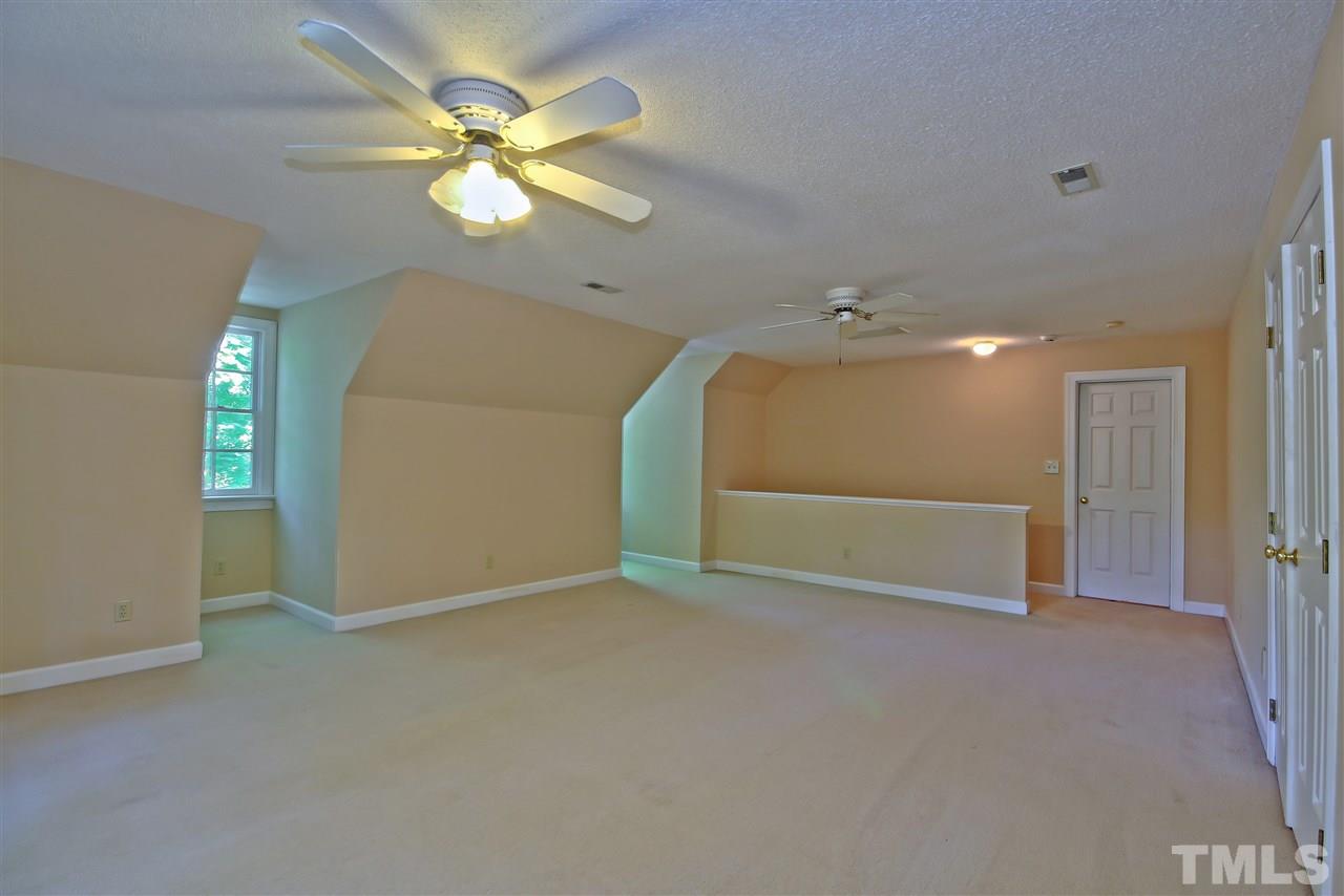 6108 Fetlock Drive Raleigh, NC 27613 - Photo 23 of 25 an empty room with fan and entrance