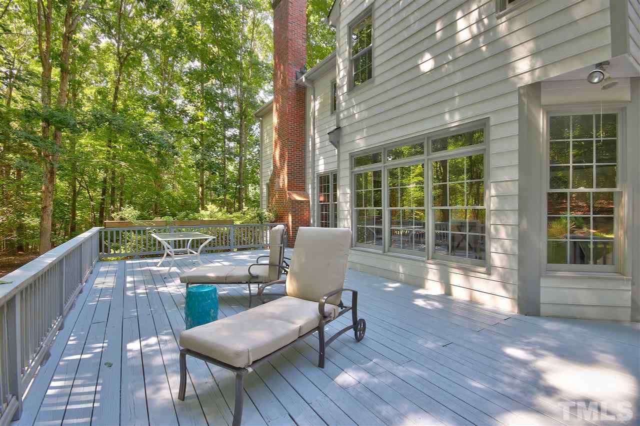 6108 Fetlock Drive Raleigh, NC 27613 - Photo 24 of 25 a view of a patio with table and chairs and wooden floor