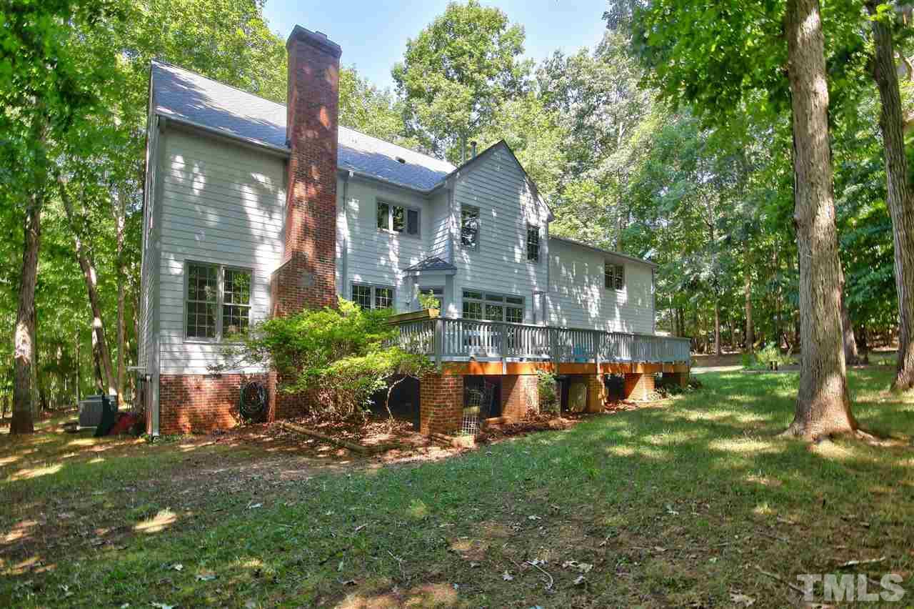 6108 Fetlock Drive Raleigh, NC 27613 - Photo 25 of 25 a view of a house with a backyard and a patio