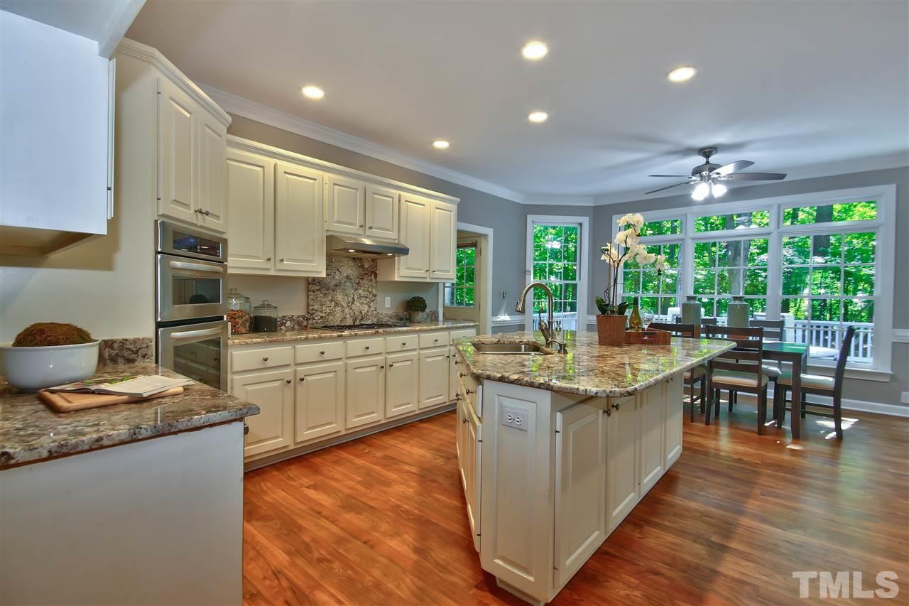 6108 Fetlock Drive Raleigh, NC 27613 - Photo 7 of 25 a kitchen with stainless steel appliances granite countertop a stove and a sink