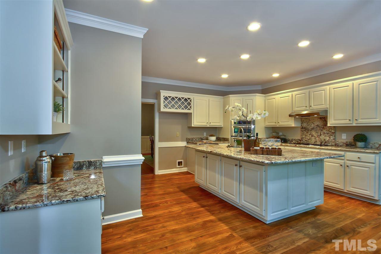 6108 Fetlock Drive Raleigh, NC 27613 - Photo 9 of 25 a kitchen with stainless steel appliances granite countertop a stove and a sink