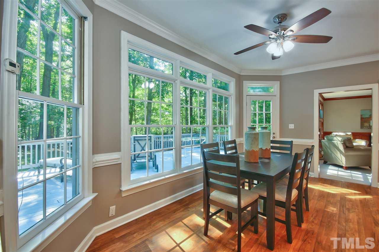 6108 Fetlock Drive Raleigh, NC 27613 - Photo 10 of 25 a dining room with furniture a chandelier and wooden floor