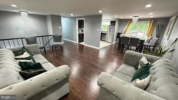 a living room with furniture and wooden floors