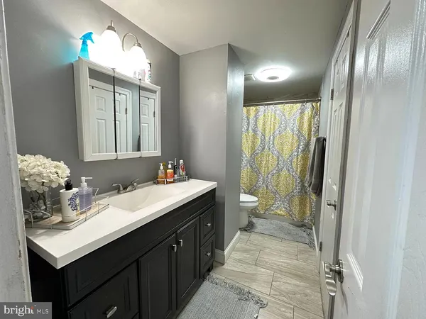 a spacious bathroom with a double vanity sink and a mirror