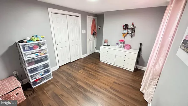 a view of bedroom with furniture and wooden floor