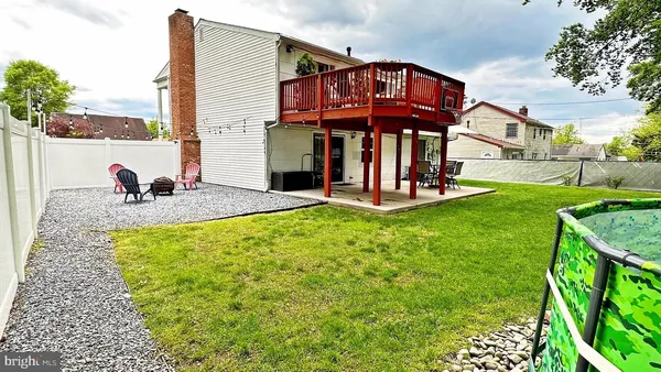 a view of a house with a yard and sitting area