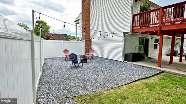 a view of a house with a yard and sitting area