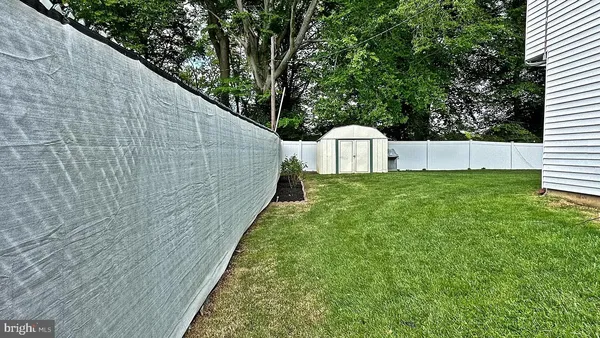 a view of a backyard with white house