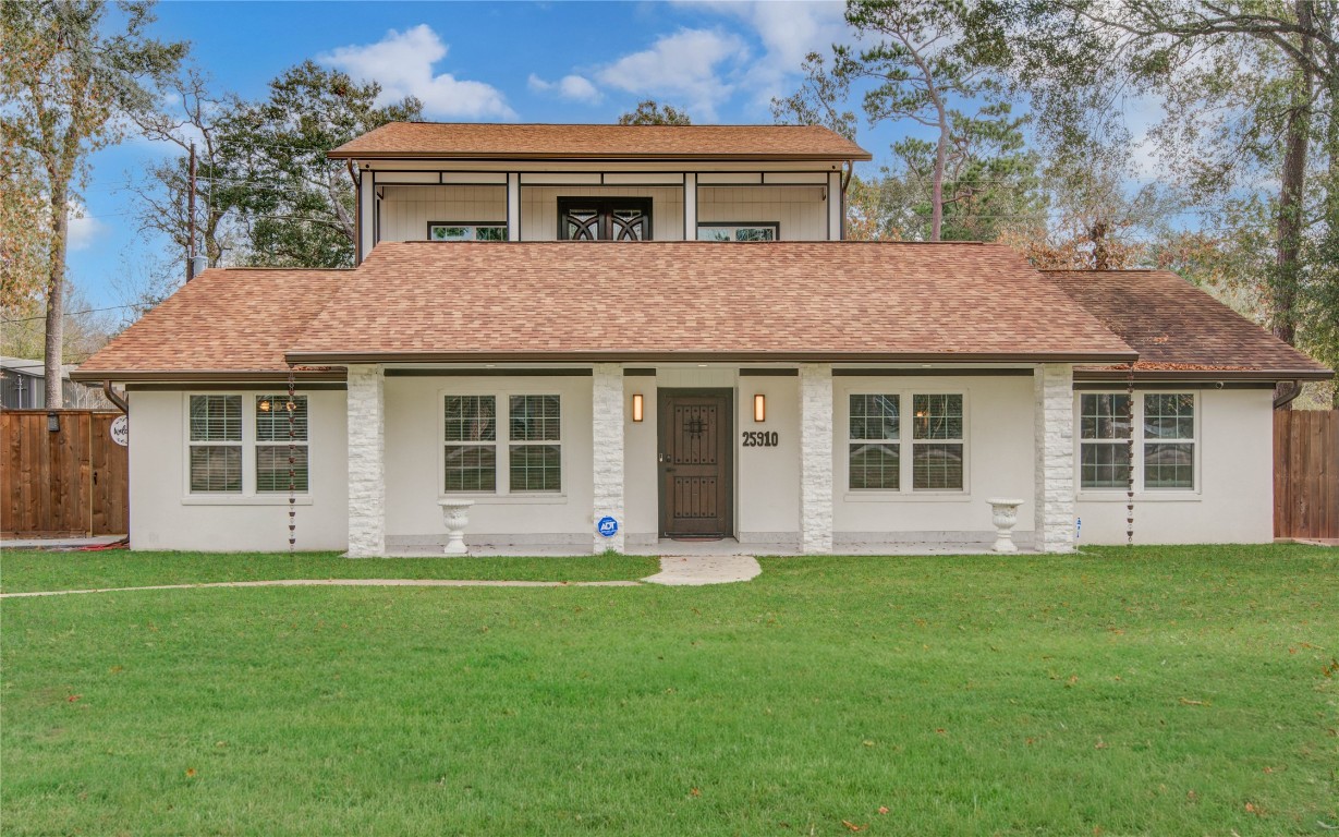 a front view of a house with a garden and porch