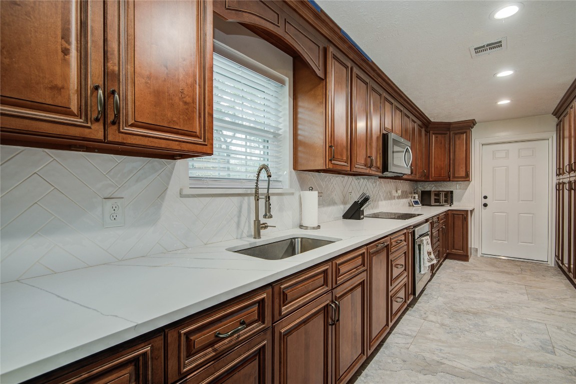 25910 Maplewood Drive Spring, TX 77386 - Photo 18 of 50 a kitchen with stainless steel appliances granite countertop a sink and cabinets