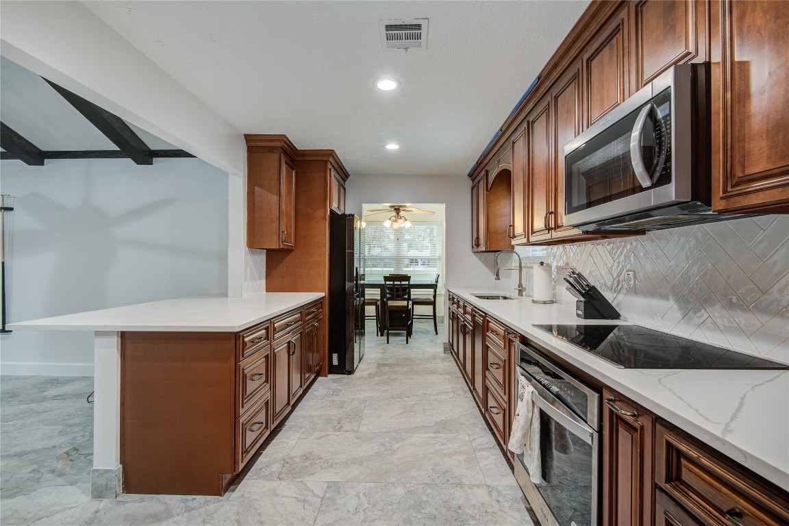 25910 Maplewood Drive Spring, TX 77386 - Photo 19 of 50 a kitchen with stainless steel appliances granite countertop a sink and a stove