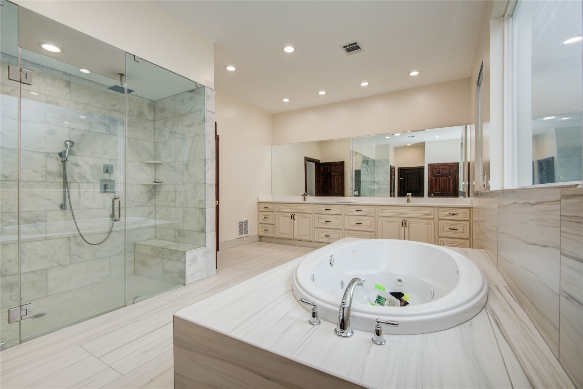 25910 Maplewood Drive Spring, TX 77386 - Photo 26 of 50 a bathroom with a bathtub and a shower