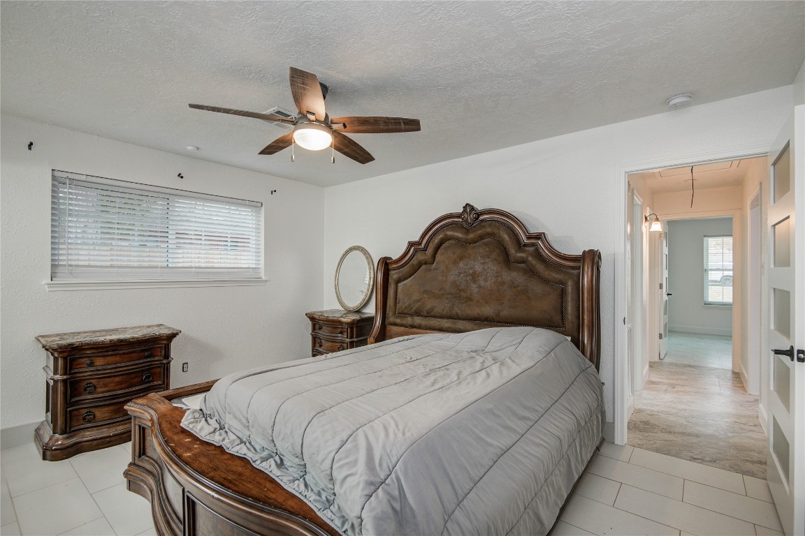 25910 Maplewood Drive Spring, TX 77386 - Photo 38 of 50 a bedroom with a bed and a chandelier