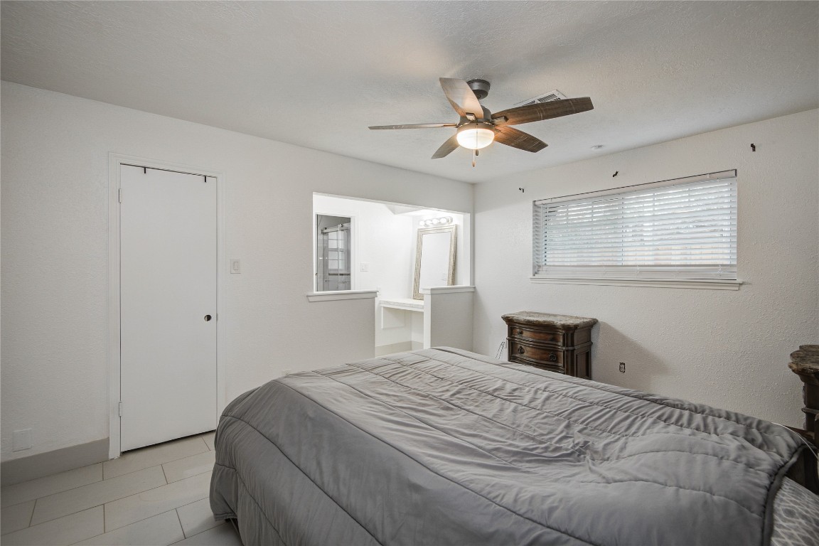 25910 Maplewood Drive Spring, TX 77386 - Photo 39 of 50 a bedroom with a large bed and a chandelier