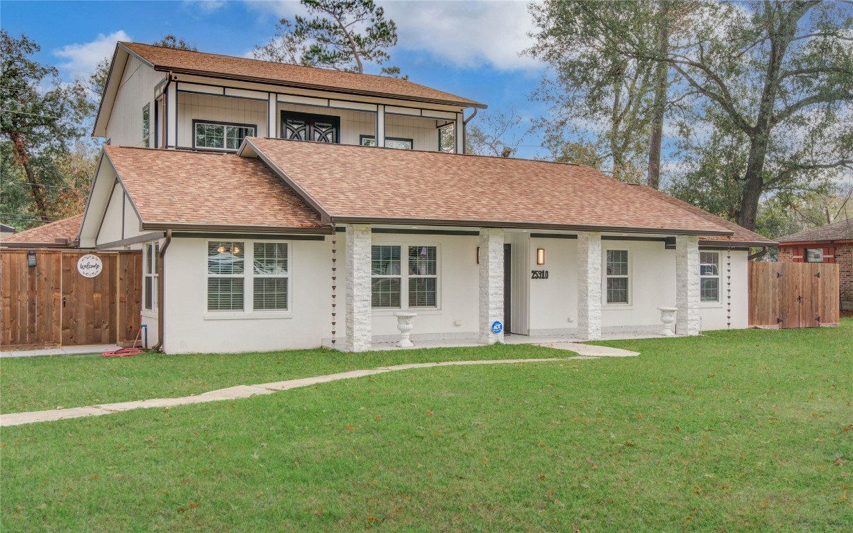 25910 Maplewood Drive Spring, TX 77386 - Photo 4 of 50 a front view of a house with a garden and trees