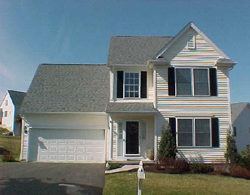 127 Logging Trail Road, Unit 127 Danbury, CT 06811 - Photo 1 of 1 a front view of a house with a yard