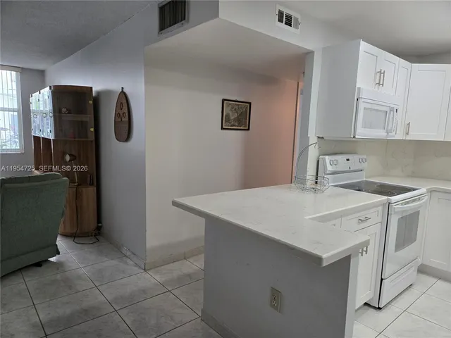 a kitchen with a sink cabinets and appliances