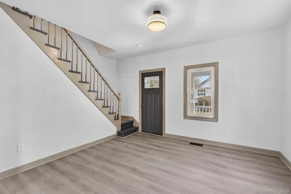 a view of an entryway with wooden floor