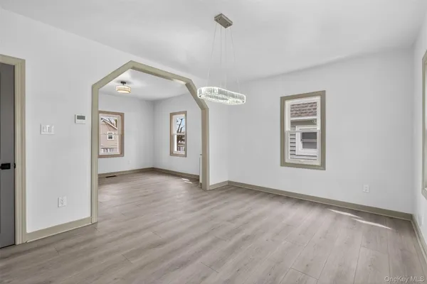 an empty room with windows and closet