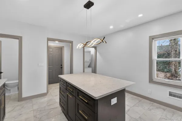 a kitchen with a stove a refrigerator and a sink