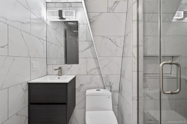 a bathroom with a toilet sink and mirror