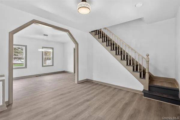 a view of an entryway with wooden floor