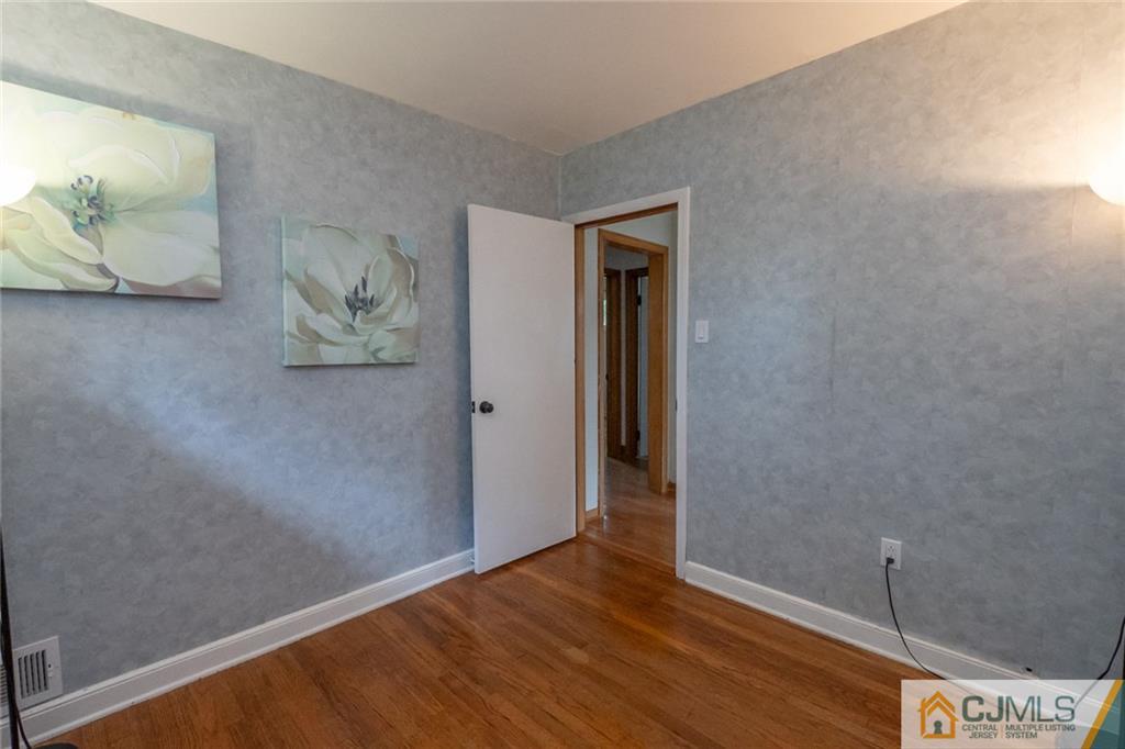 94 Oxford Road Colonia, NJ 07067 - Photo 16 of 27 a view of an empty room and wooden floor