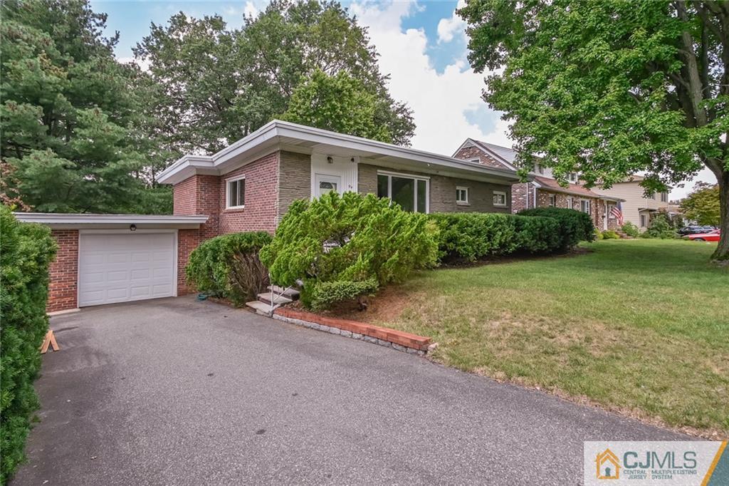 94 Oxford Road Colonia, NJ 07067 - Photo 2 of 27 a view of a house with yard and a garden