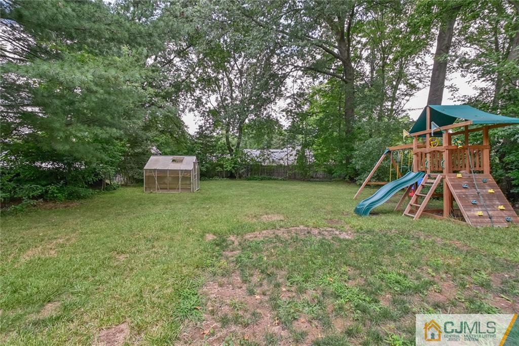 94 Oxford Road Colonia, NJ 07067 - Photo 4 of 27 a view of a backyard with a garden and trees