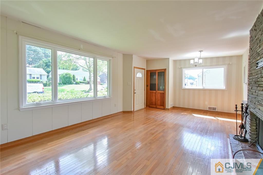 94 Oxford Road Colonia, NJ 07067 - Photo 7 of 27 a view of an empty room with wooden floor and a window