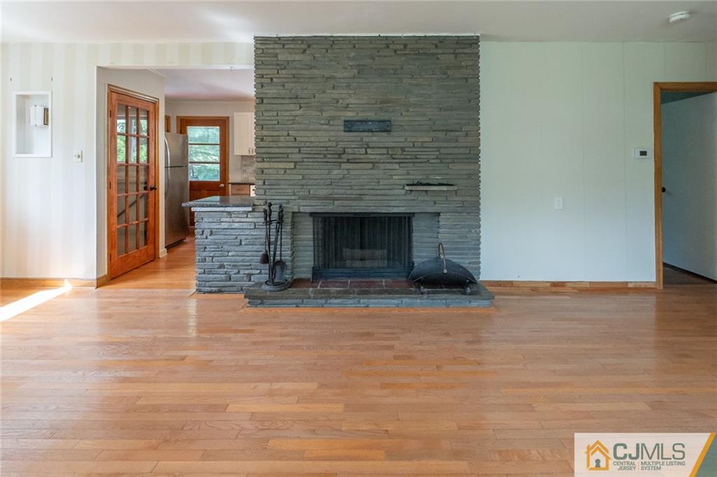 94 Oxford Road Colonia, NJ 07067 - Photo 9 of 27 a view of empty room with wooden floor and fireplace