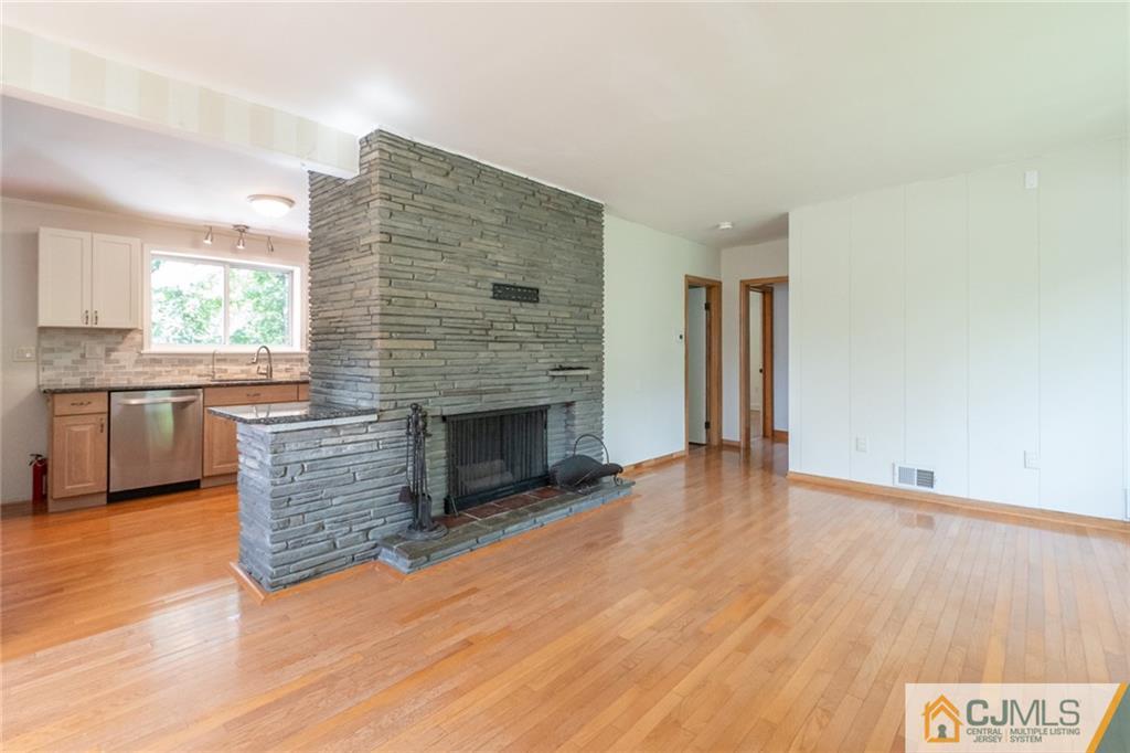 94 Oxford Road Colonia, NJ 07067 - Photo 10 of 27 a view of empty room with wooden floor and fireplace