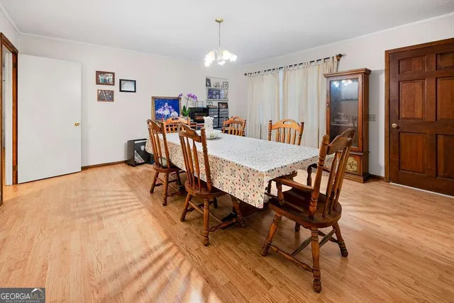 a view of a dining room with furniture and a kitchen