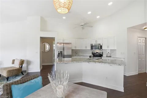 a kitchen with stainless steel appliances kitchen island granite countertop a sink and cabinets