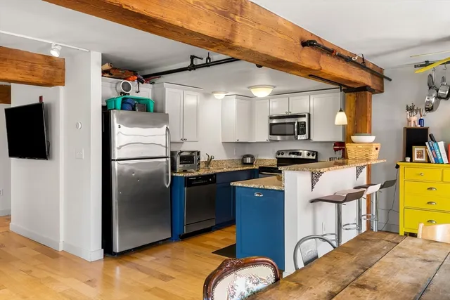 a kitchen with a refrigerator and a stove top oven