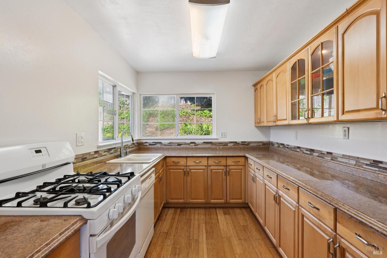546 Pinewood Drive San Rafael, CA 94903 - Photo 14 of 52 a kitchen with stainless steel appliances a sink stove and cabinets